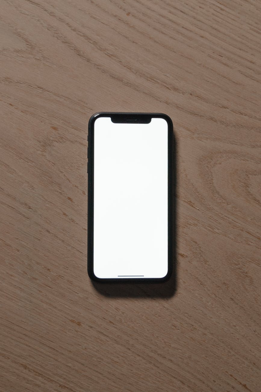 a smartphone with blank screen on a wooden table